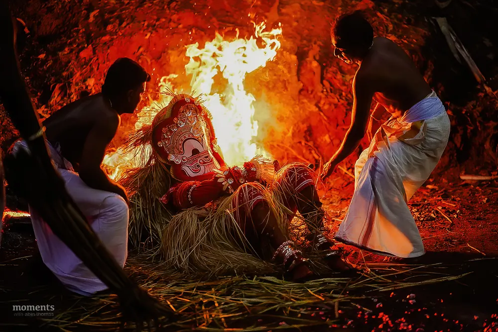 Theyyam performer in fiery costume